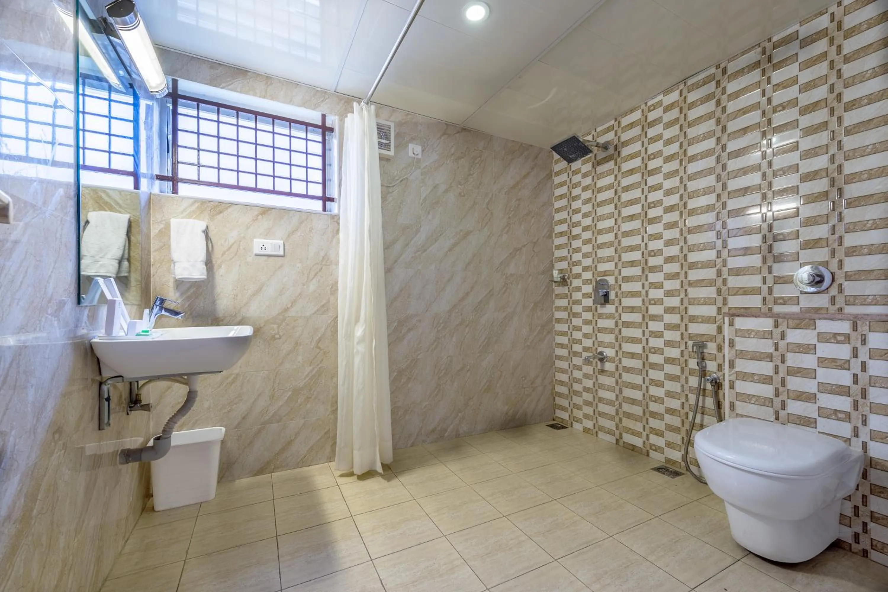 Bathroom in Treebo Akshaya Lalbagh Inn