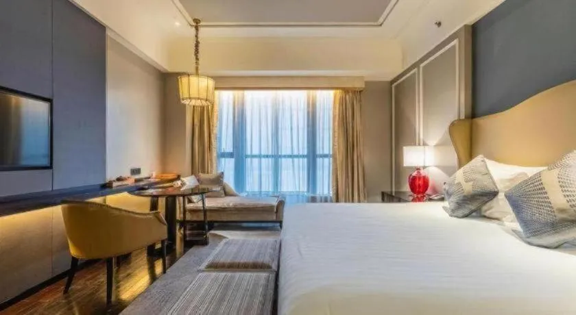 Bed in Grand New Century Hotel Yixing