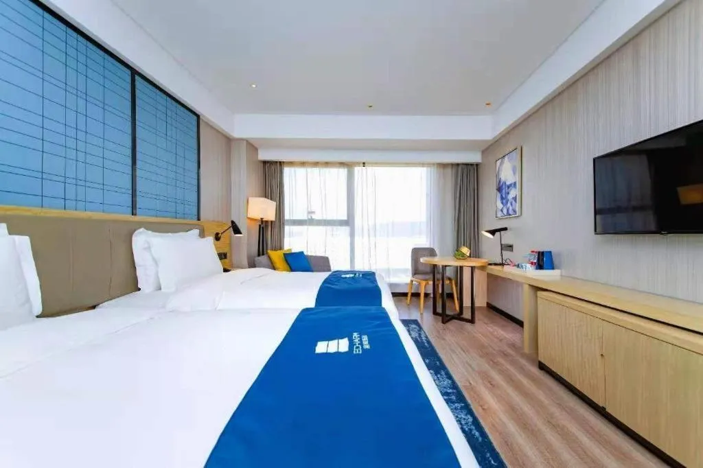 Bed in Echarm Hotel Xiantao Yuantai Weilaicheng