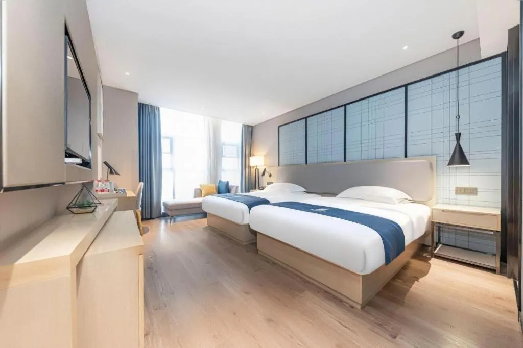 Bed in Echarm Hotel Xiantao Yuantai Weilaicheng