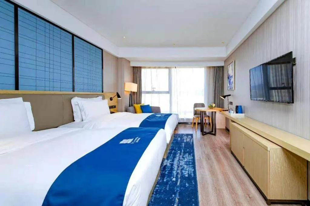 Bed in Echarm Hotel Xiantao Yuantai Weilaicheng