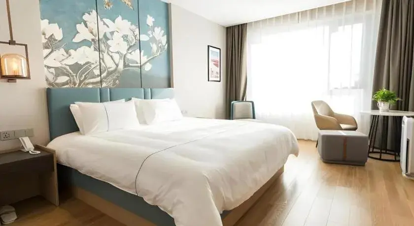 Bed in Magnotel Huludao Xingcheng Central Square Wenquan Street Bed in Magnotel Huludao Xingcheng Central Square Wenquan Street