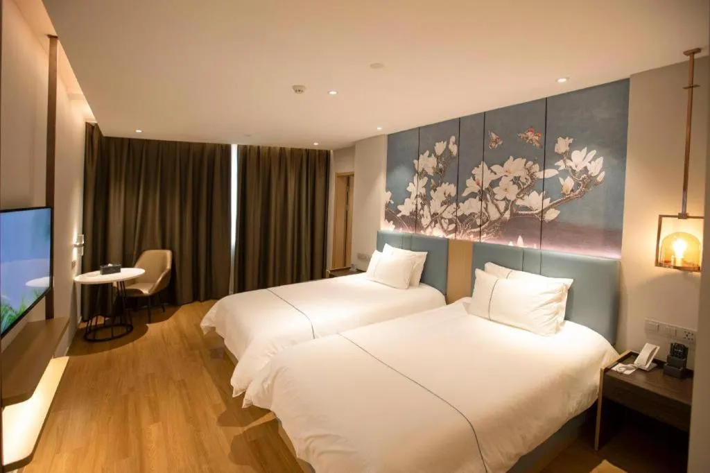 Bed in Magnotel Hotel Dongxing Guomen Port