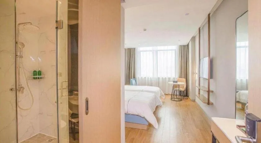 Bed in Magnotel Hotel Dongxing Guomen Port