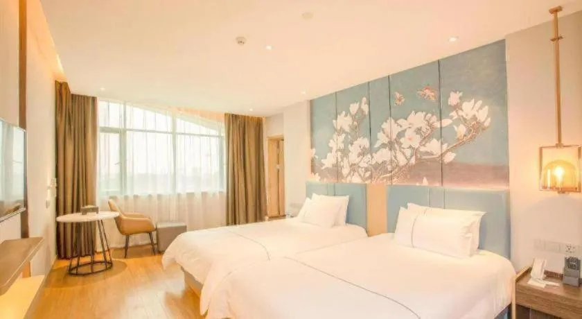Bed in Magnotel Hotel Dongxing Guomen Port