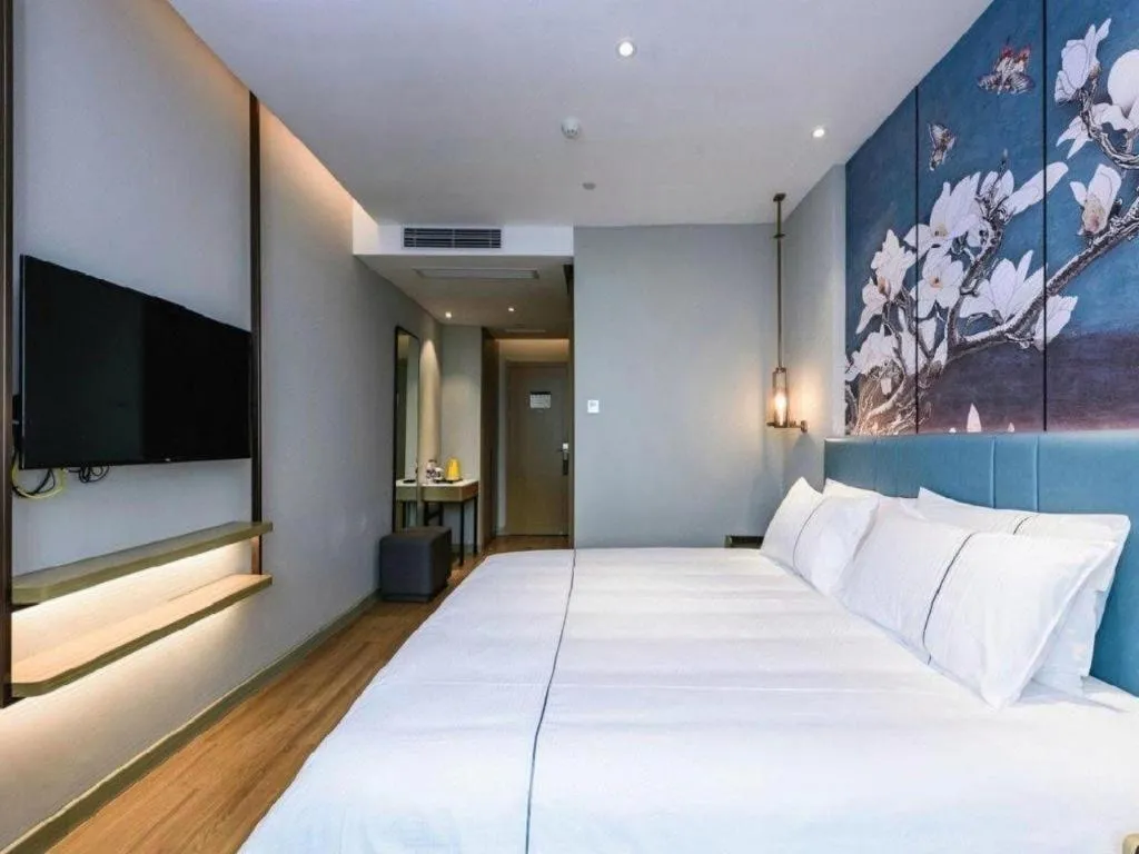 Bed in Magnotel Hotel Dongxing Guomen Port