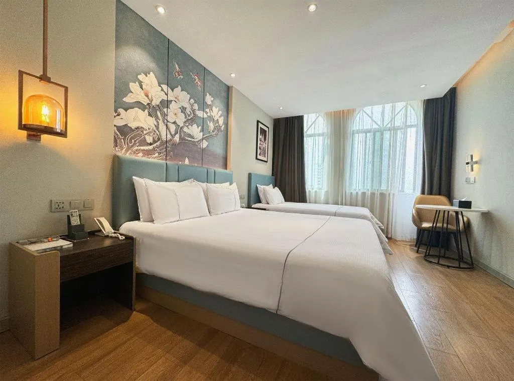Bed in Magnotel Hotel Dongxing Guomen Port