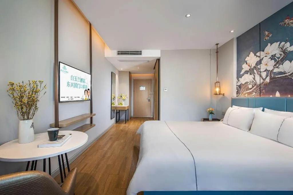 Bed in Magnotel Hotel Dongxing Guomen Port