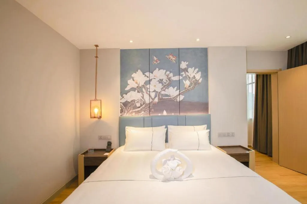 Bed in Magnotel Hotel Dongxing Guomen Port
