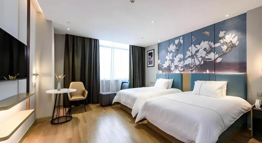 Bed in Magnotel Hotel Dongxing Guomen Port