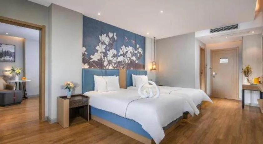 Bed in Magnotel Hotel Dongxing Guomen Port