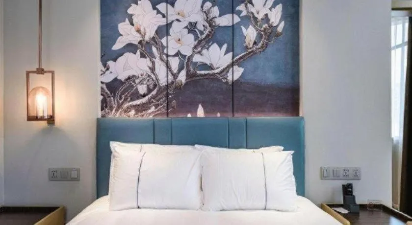 Bed in Magnotel Hotel Dongxing Guomen Port