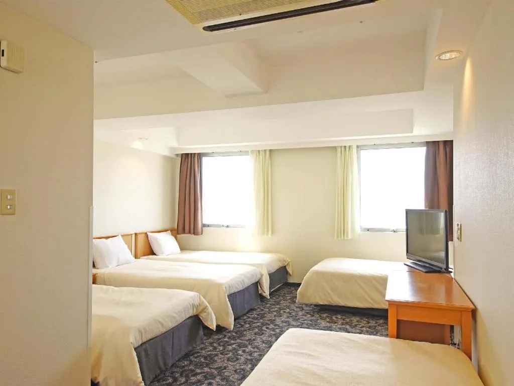 Bed in Nansei Kanko Hotel