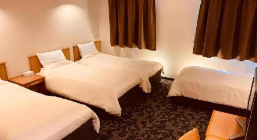 Bed in Nansei Kanko Hotel