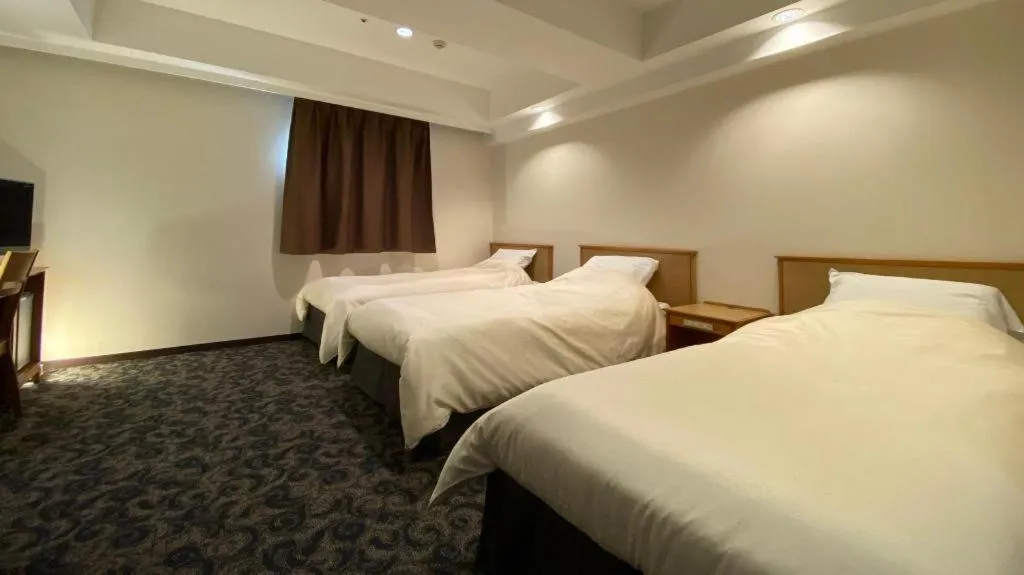 Bed in Nansei Kanko Hotel