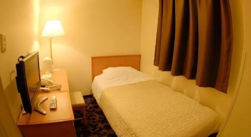 Bed in Nansei Kanko Hotel