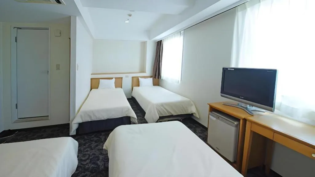 Bed in Nansei Kanko Hotel