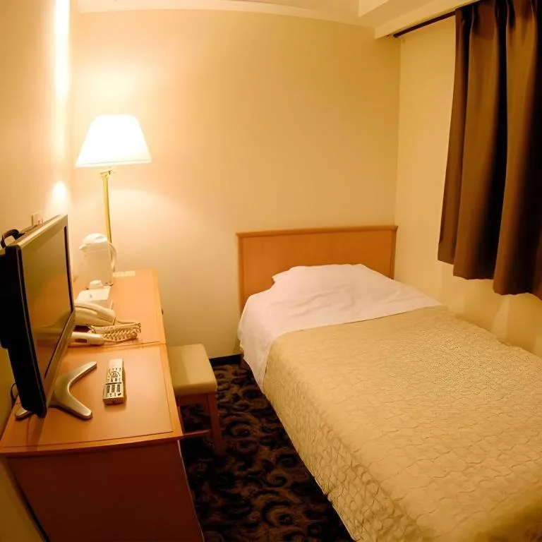 Bed in Nansei Kanko Hotel