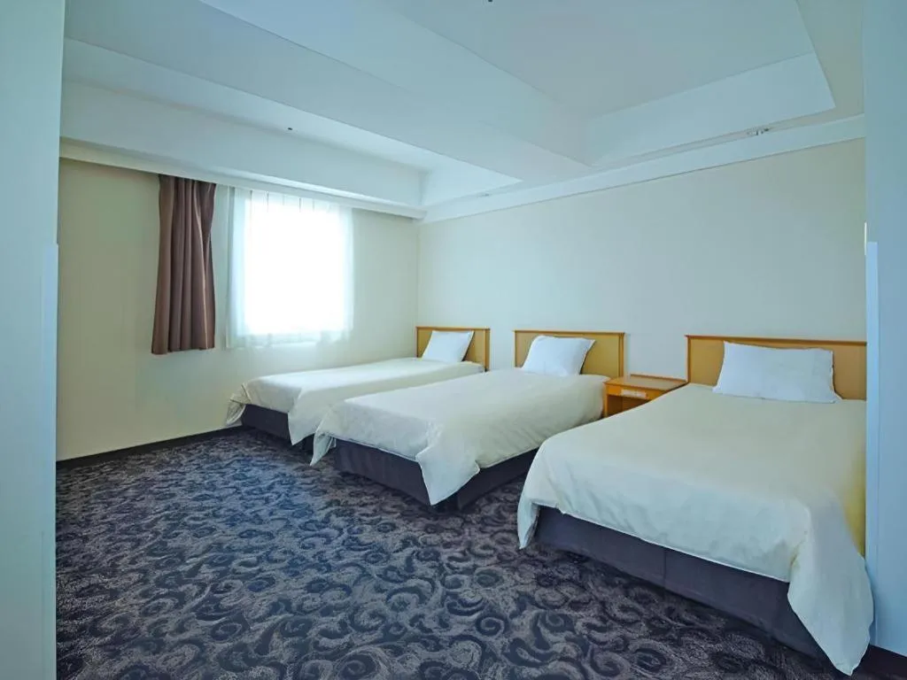 Bed in Nansei Kanko Hotel