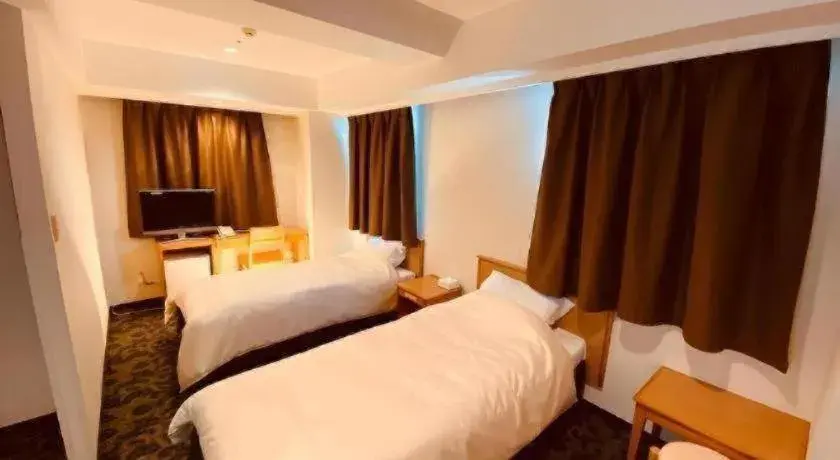 Bed in Nansei Kanko Hotel Bed in Nansei Kanko Hotel