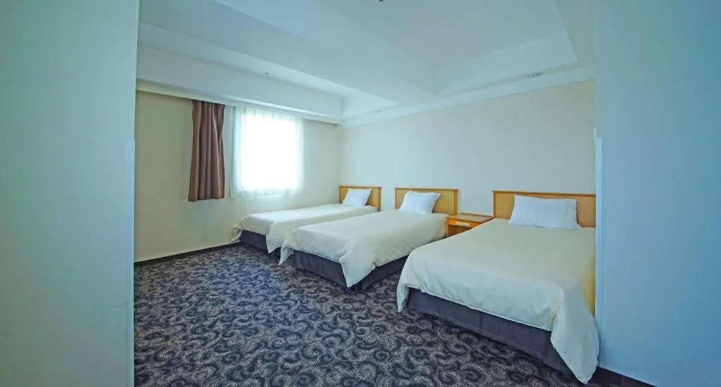 Bed in Nansei Kanko Hotel