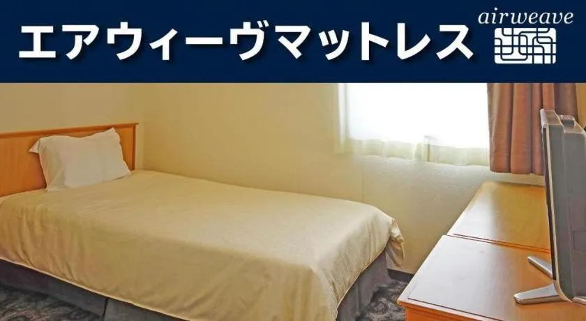 Bed in Nansei Kanko Hotel