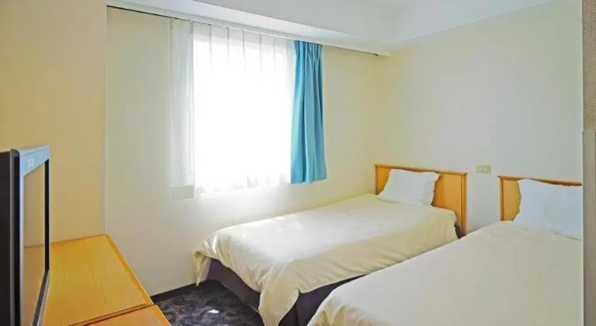 Bed in Nansei Kanko Hotel