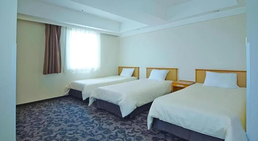 Bed in Nansei Kanko Hotel