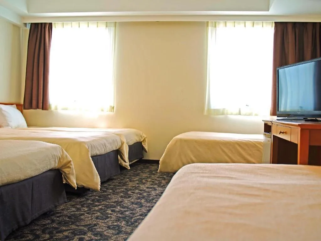 Bed in Nansei Kanko Hotel