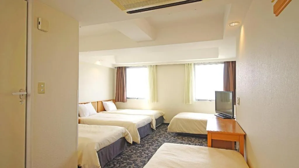 Bed in Nansei Kanko Hotel