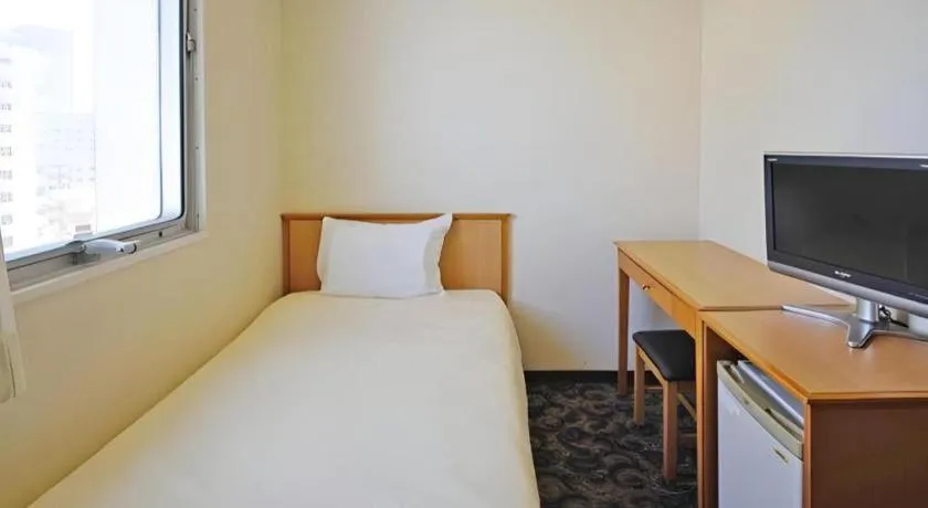 Bed in Nansei Kanko Hotel