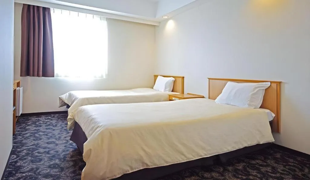 Bed in Nansei Kanko Hotel