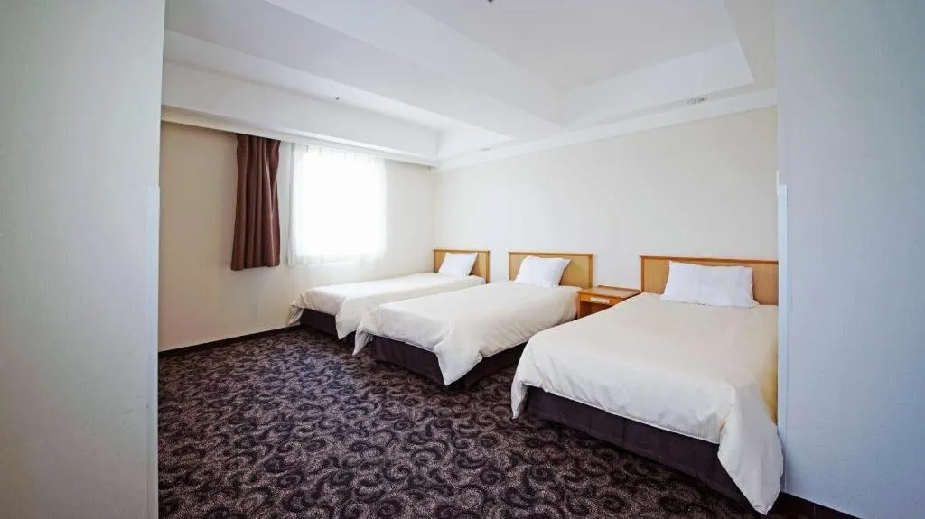 Bed in Nansei Kanko Hotel