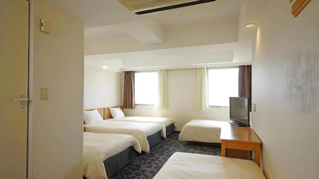 Bed in Nansei Kanko Hotel