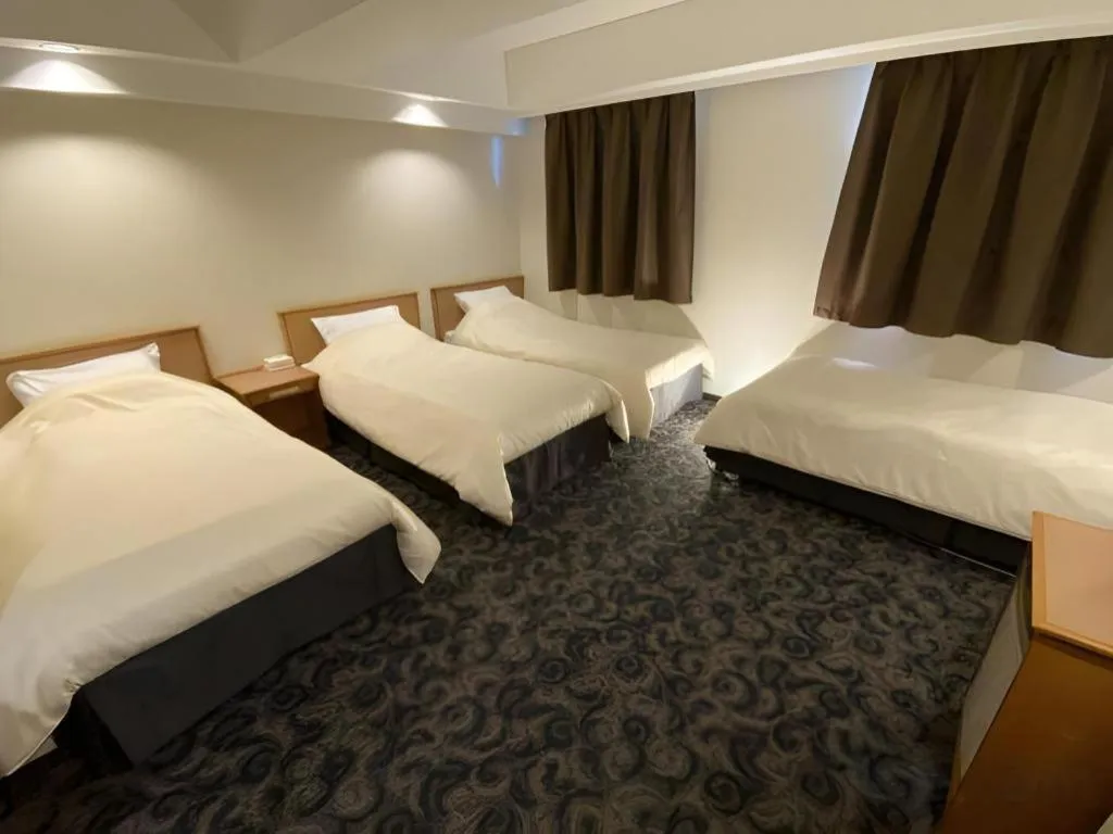 Bed in Nansei Kanko Hotel