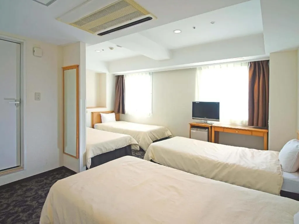 Bed in Nansei Kanko Hotel