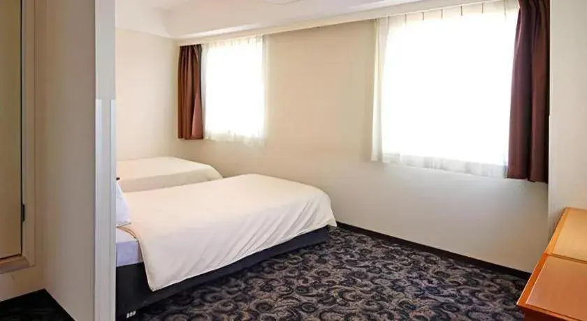 Bed in Nansei Kanko Hotel Bed in Nansei Kanko Hotel