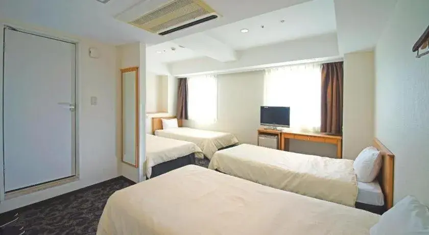 Bed in Nansei Kanko Hotel Bed in Nansei Kanko Hotel