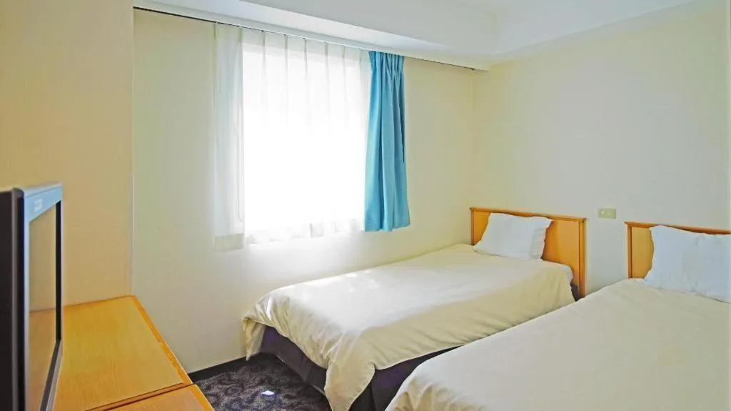 Bed in Nansei Kanko Hotel