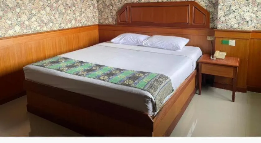 Bed in Sakol Grand Palace Hotel