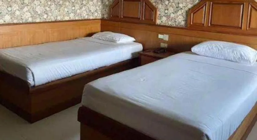 Bed in Sakol Grand Palace Hotel