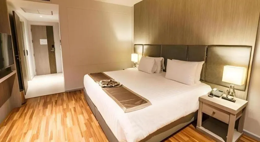 Bed in New Season Square Hotel