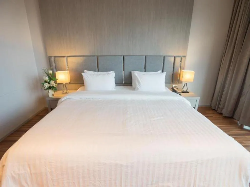 Bed in New Season Square Hotel