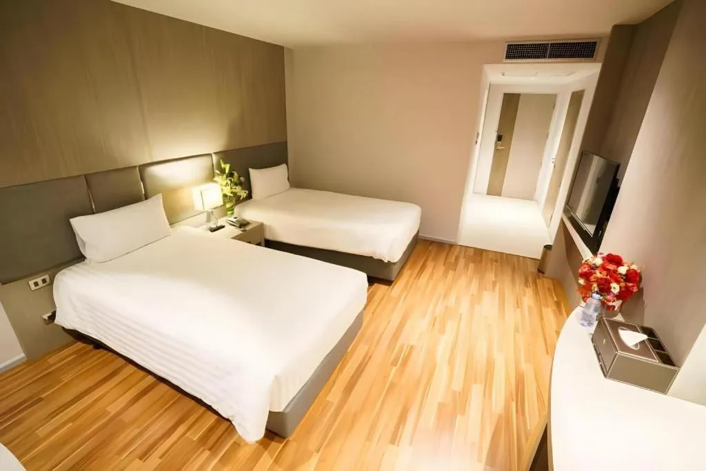 Bed in New Season Square Hotel