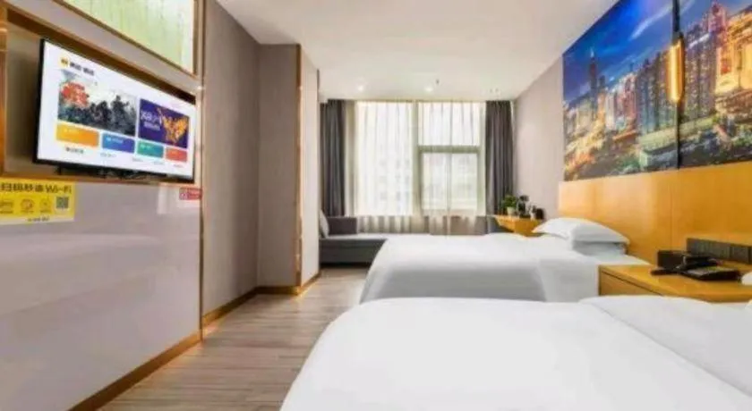 Bed in Vienna Hotel Shenzhen Pinghu Shuangyong Street Metro Station
