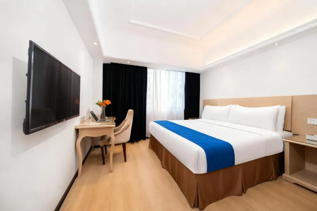 Bed in Vienna Hotel Shenzhen Pinghu Shuangyong Street Metro Station