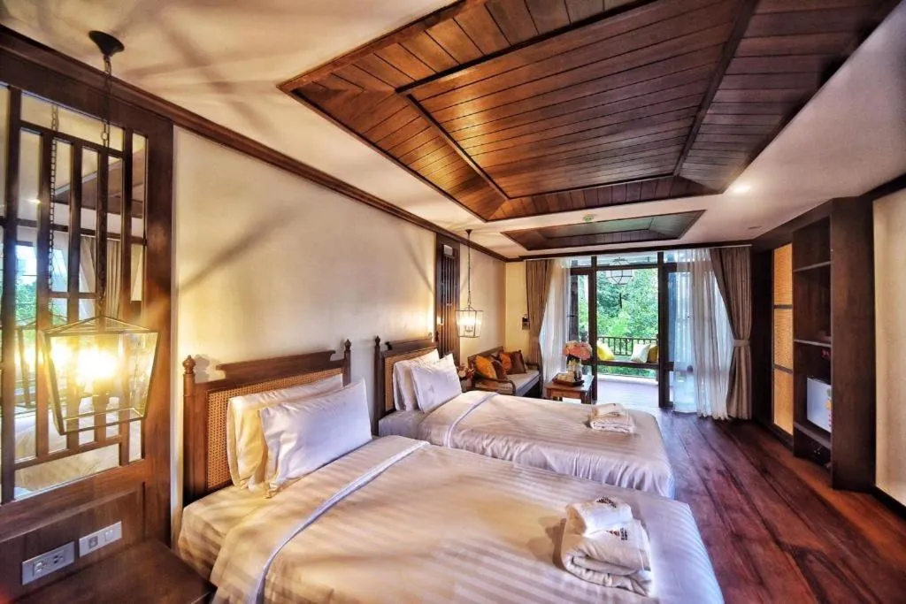 Bed in De Manor Chiang Mai Hotel