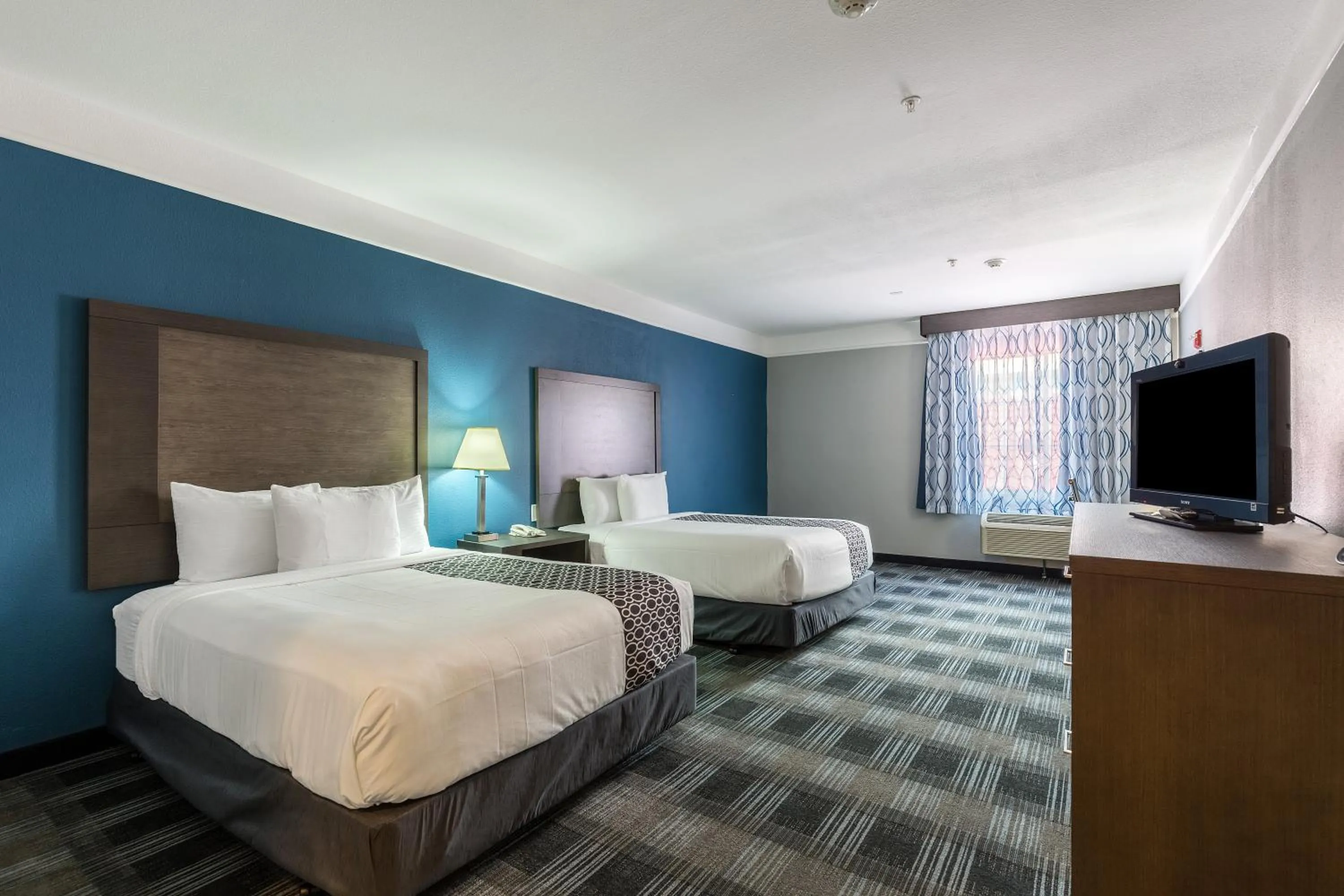 Communal lounge/ TV room, Bed in Platinum Inn & Suites Webster