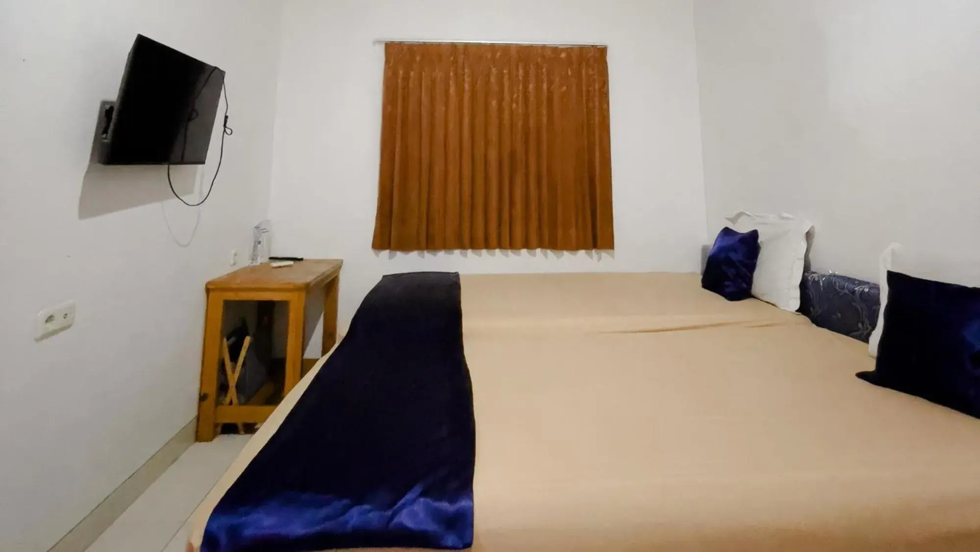 Bed in NamRoom at Tomang Bed in NamRoom at Tomang