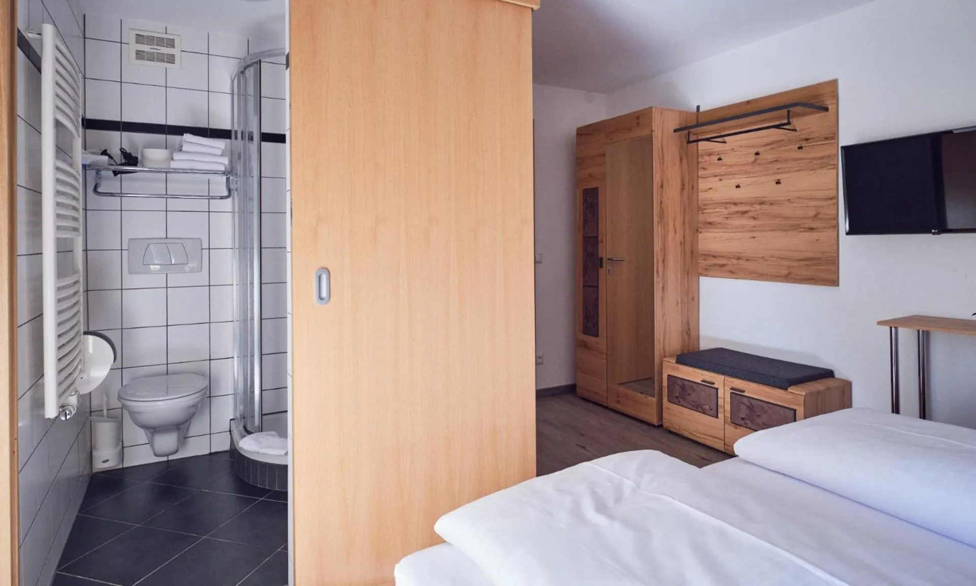 Bathroom, Bed in Hotel Pinzgauerhof by Alpeffect Hotels